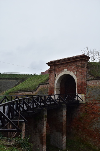Old wooden bridge and tunnel after it with a bricks