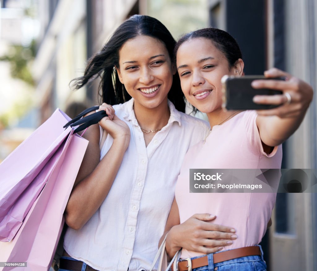 Phone selfie, shopping and friends, woman with smile and fashion sale bag on shoulder with friend. Friendship, happiness and women from Brazil taking picture with smartphone and shopping bag at mall. Latin American and Hispanic Ethnicity Stock Photo