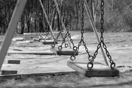Wooden swings in park. Black and white effect
