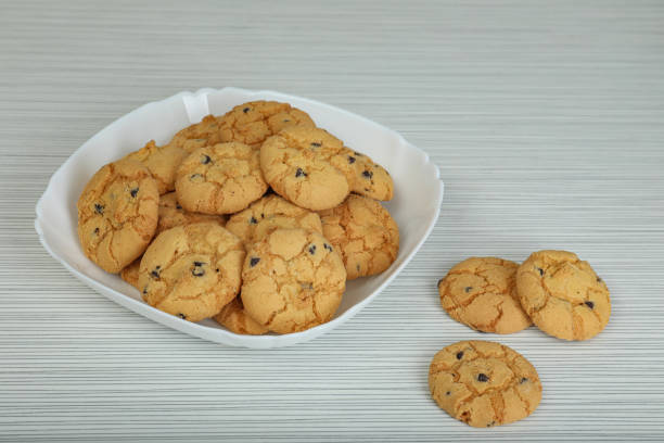 istock Delicious cookies with chocolate on white wooden table 1459694797