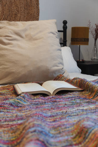 istock open book on colorful blanket on bed 1459701114