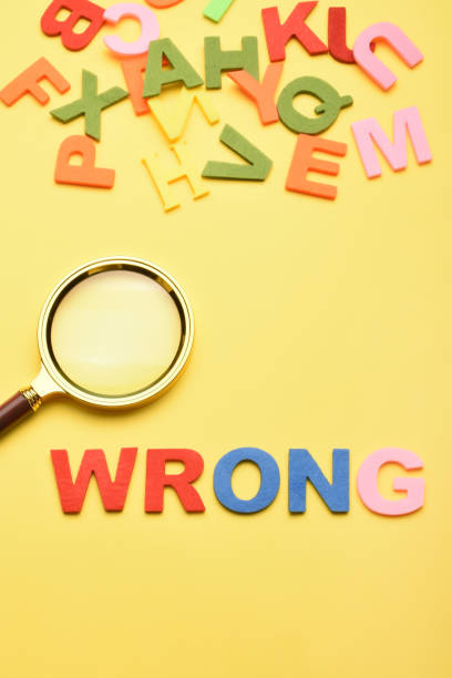 istock Word wrong and magnifying glass on the yellow background 1459702728