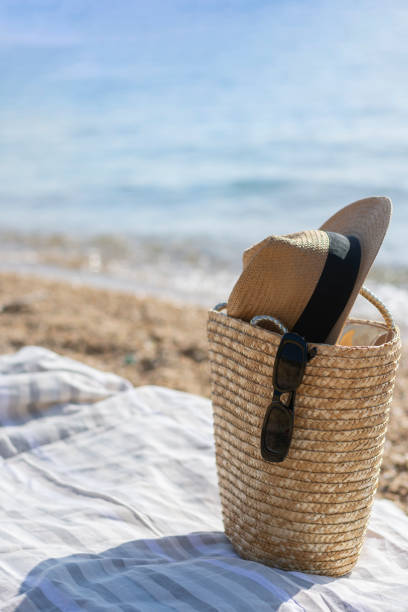 istock Sun vacation straw hat, bag, sun glasses on a tropical beach. Beach accessories 1459703971