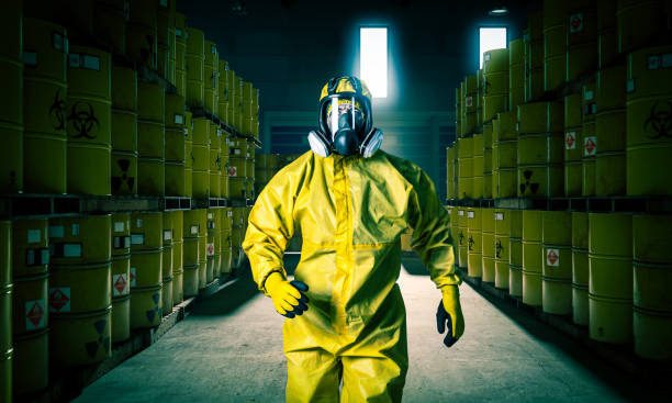 Man in mask and yellow protective clothing walks