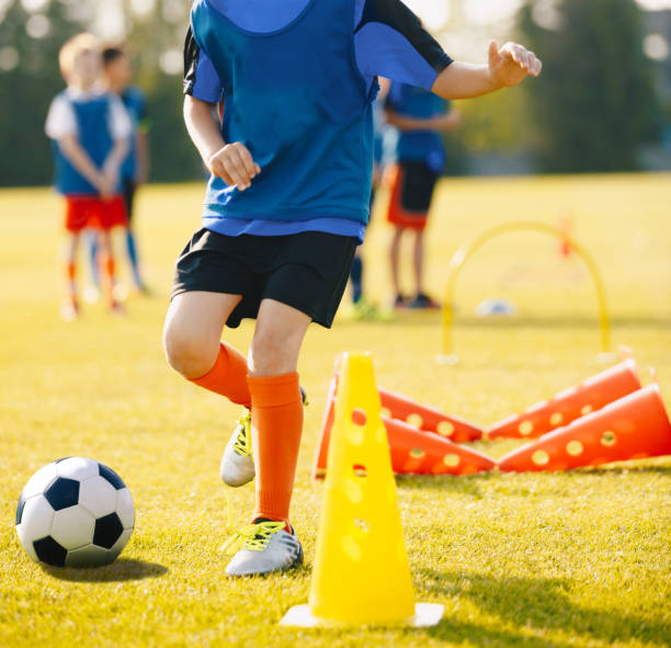 istock Boy Soccer Player In Training Drill. Young Soccer Players at Practice Session 1459705967