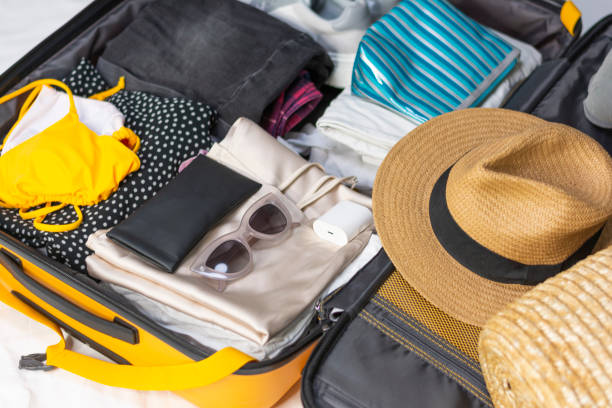istock Flat lay composition with packed suitcase and travel accessories 1459706793