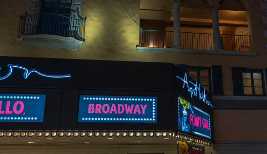 New York. USA. 09.22.2022. Night view of LED screen Broadway with Funny girl poster on August Wilson theater. Broadway shows concept.