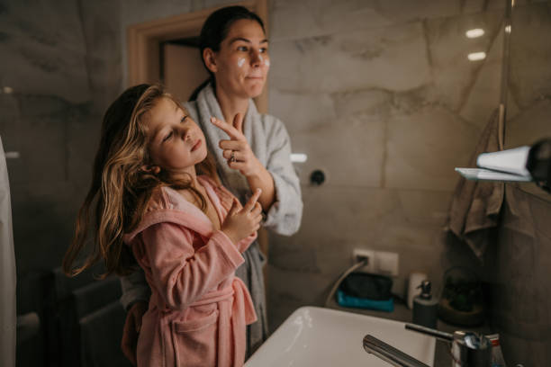istock Mom and daughter in bathroom 1459709002