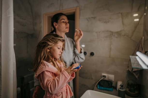 istock Mom and daughter in bathroom 1459709155