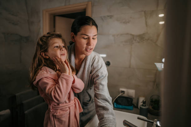 istock Mother and daughter in bathroom 1459709246