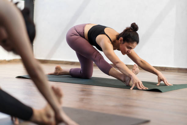 istock Female yoga instructor stretching leg and looking 1459709609