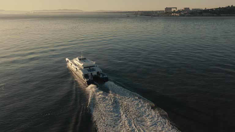 Aerial images . Sightseeing boats and ferryboat along the Lisbon riverfront,