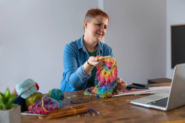 istock Learning of Knitting Wool Through Internet at Home 1459717712