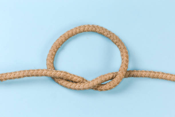 istock Rope knot as overhand knot on a blue background 1459719706