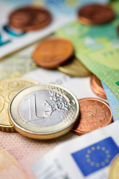 istock Euro bills and coins piled up on a table. 1459720706