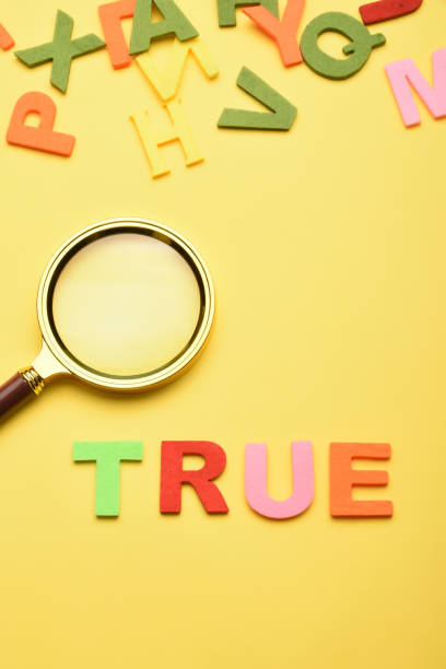istock Word true and magnifying glass on the yellow background 1459721119
