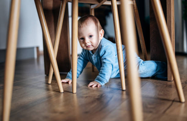 istock Baby boy having fun crawling on floor at home. 1459727132