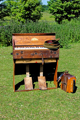 Old harmonica and piano from the time on World War 1 - Beamish Village, Durham County, England, United Kingdom, 12th of June 2021