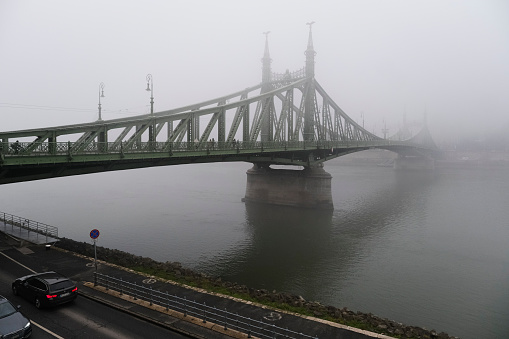 View of Margaret bridge  during a foggy day in Budapest, Hungary on December 23, 2022.