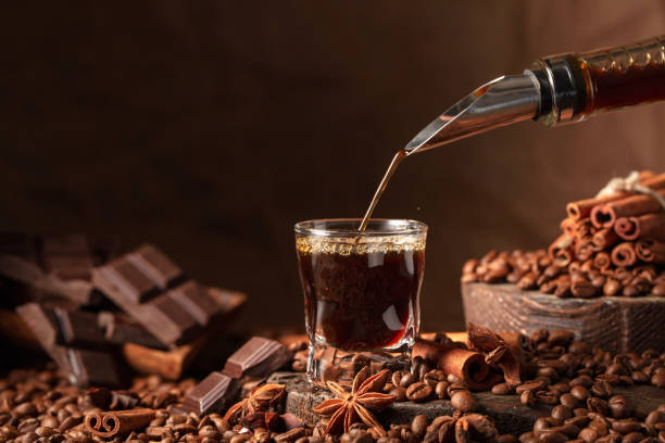 istock Coffee liquor is poured from a bottle into a glass. 1459734451