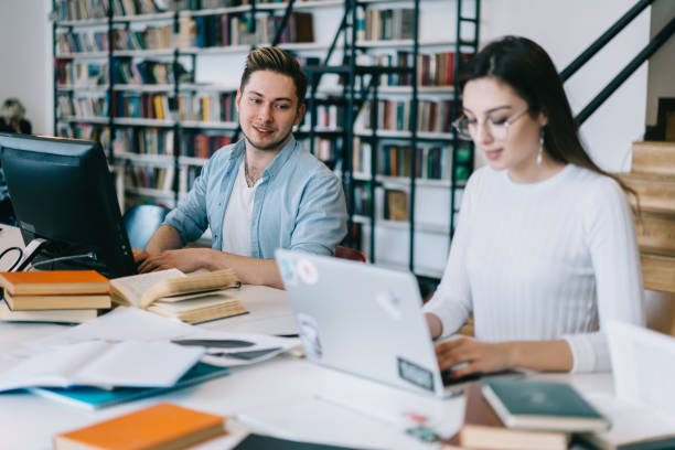istock Smart student enthusiastically looking into the work of girlfriend 1459734491