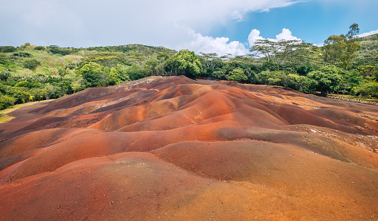 Unique seven gradual colors soil dunes - popular touristic destination on Mauritius island. Surrealistic geological formation found in the Chamarel on island's south. Beauty in Nature concept image.