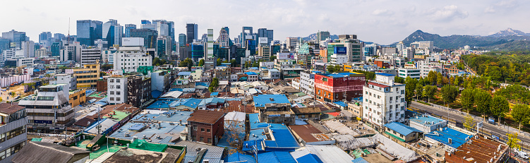 Aerial panoramic view across the crowded rooftops of central Seoul to the modern skyscraper skyline of downtown in the heart of South Korea’s vibrant capital city.