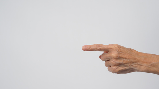 Senior or older woman hand is pointing on white background.