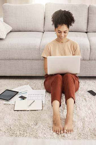 Remote work, black woman and home working of a woman on a computer planning a job schedule. Digital employee work on living room floor to plan online marketing research strategy in a house happy