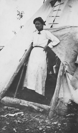 Sandy Lake, Alberta, Canada - 1913. Bigstone Cree woman in a camp at Sandy Lake in Alberta, Canada.