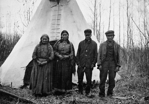 Wabasca, Alberta, Canada - 1913. Group of Bigstone Cree men and women in a camp at Wabasca in Alberta, Canada.