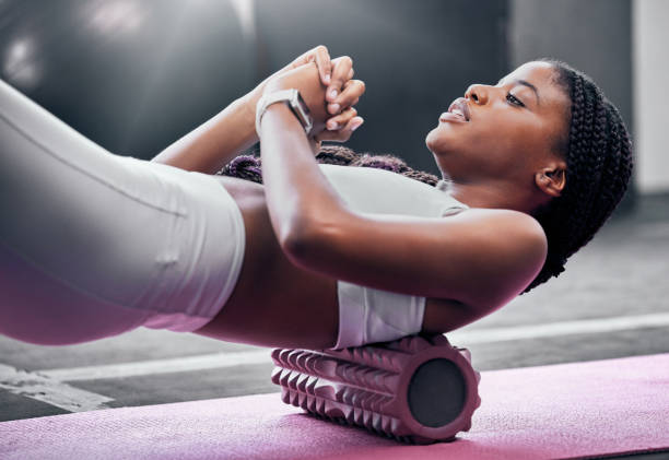 istock Fitness, exercise and foam roller with a black woman in gym,  training during a workout for health. Yoga, wellness and pilates with a female athlete exercising in a sports club for physiotherapy 1459753383
