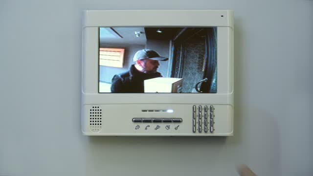 The host talking to the incoming courier via the video intercom system.