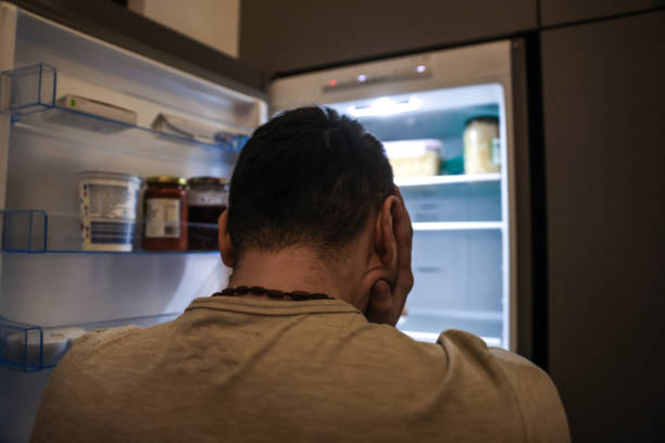 istock Upset Man In Front of an Open Fridge 1459753709