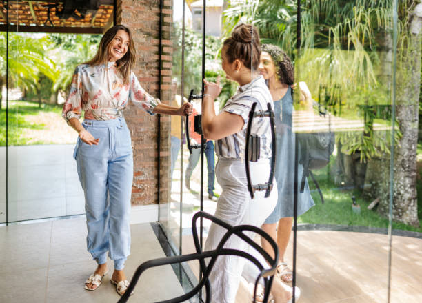 istock Smiling counselor greeting people arriving for a group therapy session 1459754285