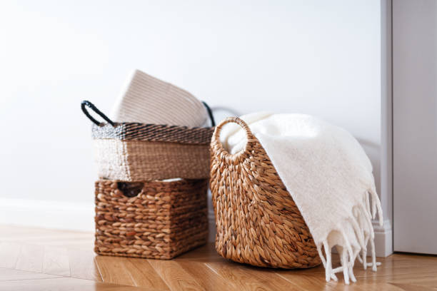 istock Stack of many woven wicker baskets for laundry on the floor, close up. Space organization system and clothes storage concept 1459755082