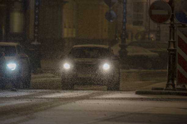 istock Car driving during a snowstorm 1459756333