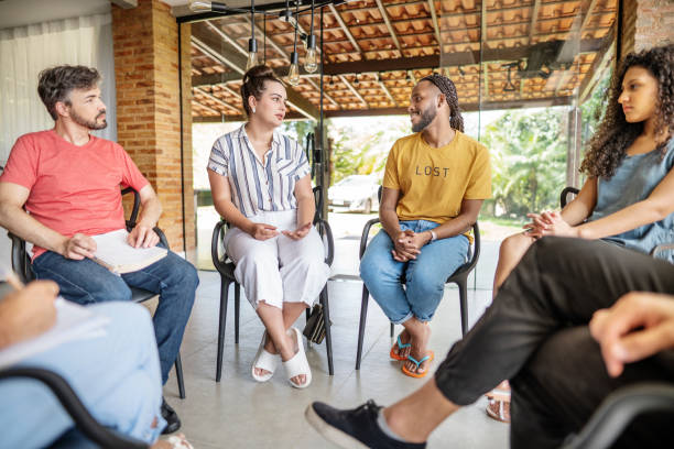 istock People talking together during a group therapy session with a counselor 1459756485