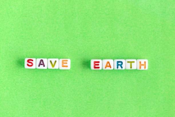 istock Phrase Save Earth made out of beads on bright green background 1459757075