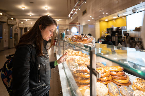 Woman checking a bakery's pastry display