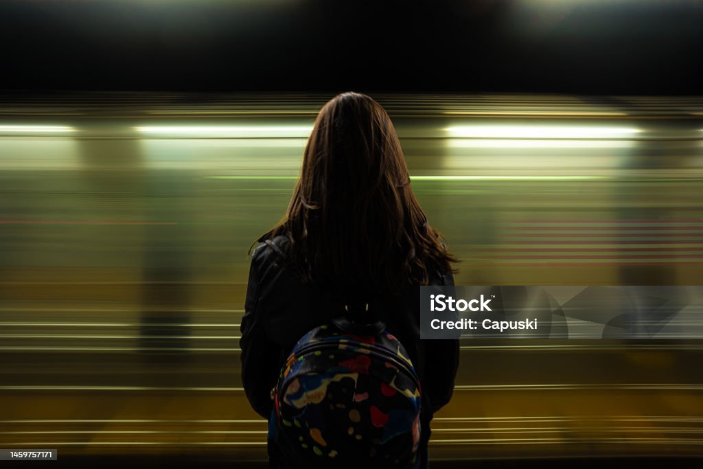 Woman watching the subway passing Holiday in New York Subway Stock Photo