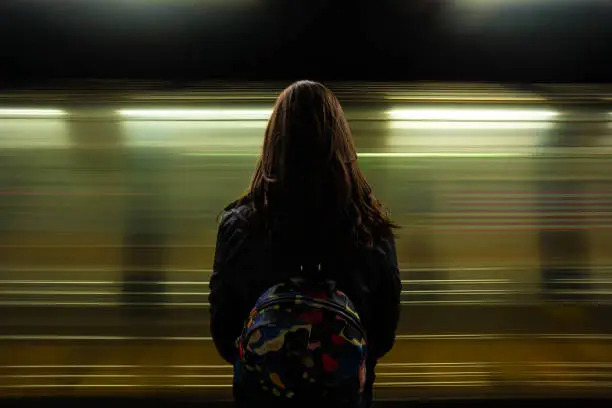 Photo of Woman watching the subway passing