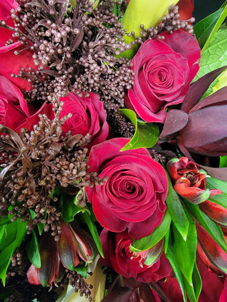 istock Red roses in a bouquet of greenery. 1459758594