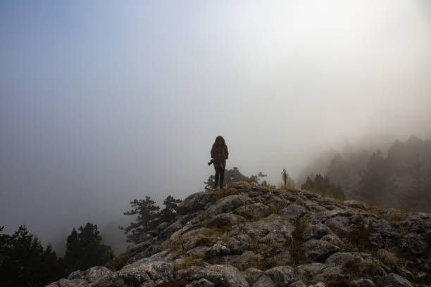 Hipster girl with a photo camera travels and enjoy nature.