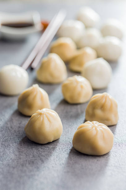istock Xiaolongbao, traditional steamed dumplings. Xiao Long Bao buns on kitchen table. 1459768102