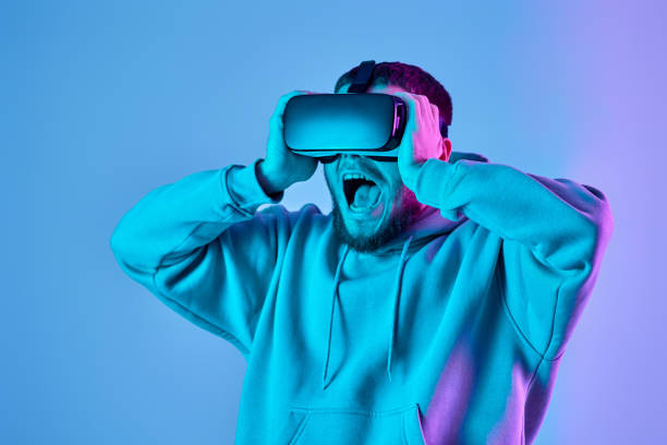 istock man using virtual reality glasses and playing video games 1459768379