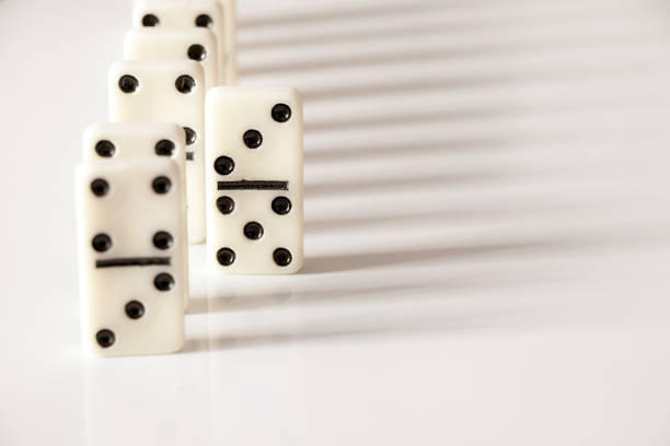 dominoes on a white background close-up, domino effect