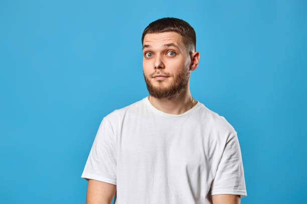 istock puzzled young bearded man in casual white t-shirt 1459771984
