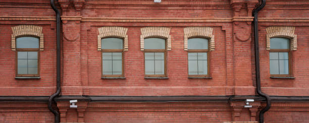 istock Old building facade with brick wall and windows row outdoor 1459775969
