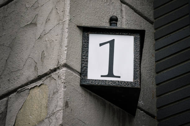 Street vintage number one plate fixed in frame on house wall
